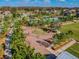 Aerial view of a community with a playground, swimming pool, and landscaped green spaces at 3312 Francoa Dr, Odessa, FL 33556