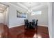 Dining room with tray ceiling, modern chandelier, and a view of the rear of the home at 3312 Francoa Dr, Odessa, FL 33556