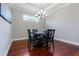 Dining room with decorative lighting fixture, dark wood floors, and a view of the window at 3312 Francoa Dr, Odessa, FL 33556