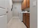 Well-lit laundry room with ample cabinet space and modern washer and dryer at 3312 Francoa Dr, Odessa, FL 33556