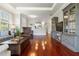 Open living space featuring hardwood floors and neutral walls with access to kitchen at 3312 Francoa Dr, Odessa, FL 33556