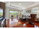 Spacious living room with hardwood floors, a large sliding glass door and tray ceiling at 3312 Francoa Dr, Odessa, FL 33556