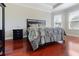 Serene main bedroom with warm wood floors, a large window, and natural light throughout at 3312 Francoa Dr, Odessa, FL 33556
