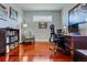 Home office with hardwood floors, a desk, an office chair, and a bookshelf at 3312 Francoa Dr, Odessa, FL 33556