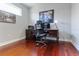 Office with hardwood floors, neutral paint, and a dark wood desk setup beneath a window at 3312 Francoa Dr, Odessa, FL 33556