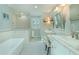 Elegant bathroom with dual sinks, marble countertops, a soaking tub, and subway tile at 3516 W Santiago St, Tampa, FL 33629