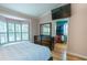 Bedroom boasts vaulted ceiling, plantation shutters, large closet access, and mounted TV at 3516 W Santiago St, Tampa, FL 33629