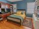 Comfortable bedroom with wood floors, built-in shelving, and a cozy bed at 3516 W Santiago St, Tampa, FL 33629
