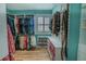 Spacious walk-in closet featuring custom shelving, hanging racks, and plenty of storage at 3516 W Santiago St, Tampa, FL 33629