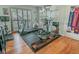 Exercise room with equipment including treadmill, weights, and hardwood flooring at 3516 W Santiago St, Tampa, FL 33629