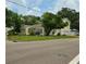 A corner lot with yellow two-story home and mature trees provides a great view at 3516 W Santiago St, Tampa, FL 33629