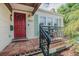 Charming single Gathering home front entry with red door, tile flooring, and shuttered window at 3516 W Santiago St, Tampa, FL 33629