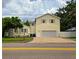 Rear view of two-story home with a large garage and a brick-paved driveway at 3516 W Santiago St, Tampa, FL 33629