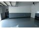 Spacious garage featuring epoxy floors, white and blue walls, with an automatic door and ample storage space at 3516 W Santiago St, Tampa, FL 33629