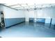 Bright garage with epoxy floors, blue and white walls, insulated ceiling, and multiple access doors at 3516 W Santiago St, Tampa, FL 33629