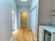 Bright hallway featuring hardwood floors, neutral walls, and easy access to the bathroom at 3516 W Santiago St, Tampa, FL 33629