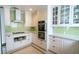 Bright updated kitchen with green backsplash, stainless appliances and gas cooktop at 3516 W Santiago St, Tampa, FL 33629