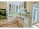 Updated kitchen featuring green backsplash, quartz counters, stainless dishwasher and farmhouse sink at 3516 W Santiago St, Tampa, FL 33629