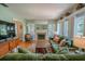 Inviting living room with fireplace, hardwood floors, large windows and shutters at 3516 W Santiago St, Tampa, FL 33629