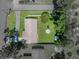 Birds eye view of the house with green back yard featuring a fire pit and storage shed at 37153 Mcminn Ave, Dade City, FL 33525