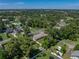 Check out this aerial view of home with fenced yard, featuring a fire pit and mature trees for privacy and shade at 37153 Mcminn Ave, Dade City, FL 33525