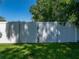 Back yard white vinyl gate with green grass on the ground at 37153 Mcminn Ave, Dade City, FL 33525