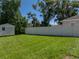 Spacious, well-manicured backyard with green lawn and a white privacy fence creating a serene outdoor space at 37153 Mcminn Ave, Dade City, FL 33525