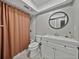 Charming bathroom with a patterned floor, modern vanity, and shower with stylish curtain at 37153 Mcminn Ave, Dade City, FL 33525