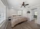 Comfortable bedroom with modern ceiling fan, neutral walls, and beautiful wood-look flooring at 37153 Mcminn Ave, Dade City, FL 33525