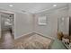 Bright, versatile bedroom with wood-look floors and a decorative vanity and mirror at 37153 Mcminn Ave, Dade City, FL 33525