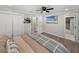 Well-lit bedroom with wood-look flooring, ceiling fan, and an ensuite bathroom at 37153 Mcminn Ave, Dade City, FL 33525