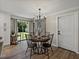 Elegant dining area with modern chandelier and views of the backyard, adjacent to the well-appointed kitchen at 37153 Mcminn Ave, Dade City, FL 33525