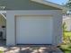 Close-up of the white garage door featuring a classic paneled design, complementing the home's exterior at 37153 Mcminn Ave, Dade City, FL 33525