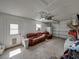 A spacious garage with a leather sofa and chair, and a large garage door at 37153 Mcminn Ave, Dade City, FL 33525