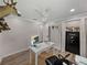 Bright home office featuring neutral walls, a white ceiling, and a white desk with wood-look flooring at 37153 Mcminn Ave, Dade City, FL 33525