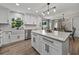 Kitchen featuring white cabinets, stainless steel appliances, and a central island with barstool seating at 37153 Mcminn Ave, Dade City, FL 33525