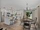 Bright, modern kitchen with white cabinetry, stainless steel appliances, and a stylish island with seating at 37153 Mcminn Ave, Dade City, FL 33525