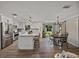 Well-lit kitchen with stainless steel appliances, white cabinetry, and an island with barstool seating at 37153 Mcminn Ave, Dade City, FL 33525