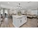Open-concept living space featuring a modern island, dining area, and a cozy living room at 37153 Mcminn Ave, Dade City, FL 33525