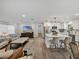 Open-concept living space with modern finishes, including a kitchen island and a large television at 37153 Mcminn Ave, Dade City, FL 33525