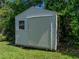 Durable storage shed with a sliding door and window, providing convenient storage solutions in the backyard at 37153 Mcminn Ave, Dade City, FL 33525