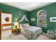 Charming bedroom with green walls, canopy over bed, and decorative accents at 3772 Woodridge Pl, Palm Harbor, FL 34684