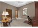 Bedroom with beige walls, built-in closet and desk, and arched window at 3772 Woodridge Pl, Palm Harbor, FL 34684