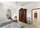 Bright bedroom features two beds, a ceiling fan, and a large wooden wardrobe at 3772 Woodridge Pl, Palm Harbor, FL 34684