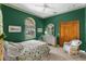 Inviting bedroom with green walls, arched window, and classic furnishings at 3772 Woodridge Pl, Palm Harbor, FL 34684