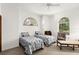 Bright bedroom with two twin beds and arched windows providing natural light and charm at 3772 Woodridge Pl, Palm Harbor, FL 34684