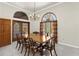 Formal dining room with large windows, chandelier, and seating for eight at 3772 Woodridge Pl, Palm Harbor, FL 34684