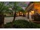 Elegant brick home with lush landscaping, arched entryway, garage and paved driveway at 3772 Woodridge Pl, Palm Harbor, FL 34684