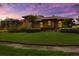 Expansive brick home with well-manicured lawn and lush landscaping at 3772 Woodridge Pl, Palm Harbor, FL 34684
