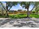 Beautiful brick home featuring a screened in patio, lush landscaping, and mature trees in a well-manicured lawn at 3772 Woodridge Pl, Palm Harbor, FL 34684
